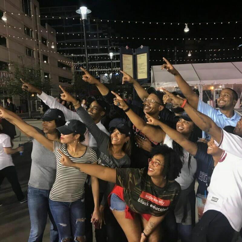 HUAA Campus Pals members pointing and posing for large group photo