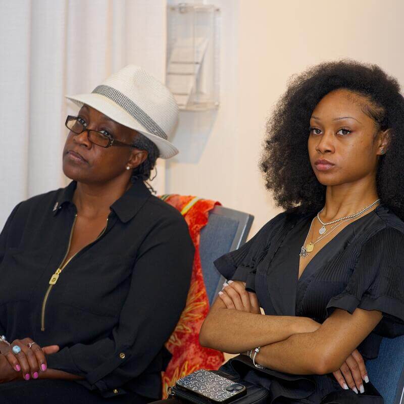 Two female audience members listening