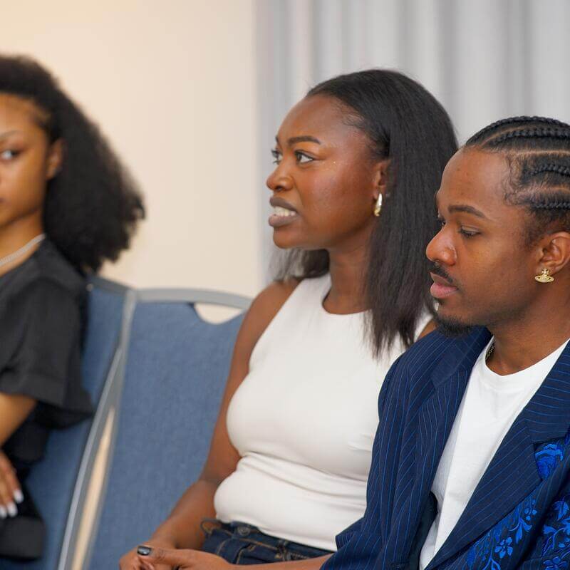 3 audience members listening