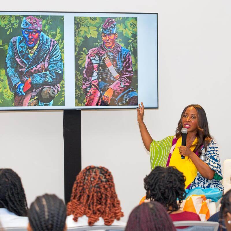 speakers explaining art to audience