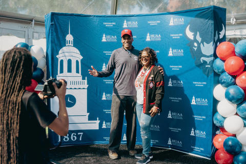 Two alumni get their photo taken at Homecoming