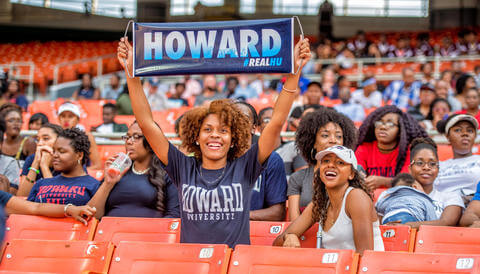 alumni in stands cheering