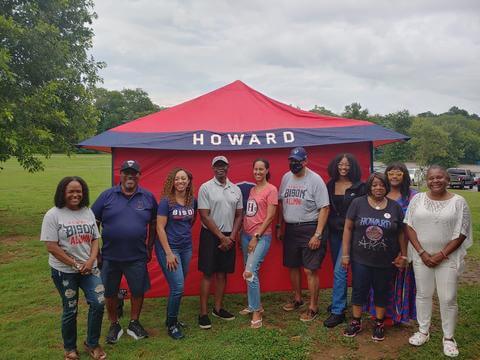 HUAC Richmond members posing for a photo under a Howard tent