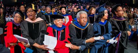 Faculty holding hands at Charter Day