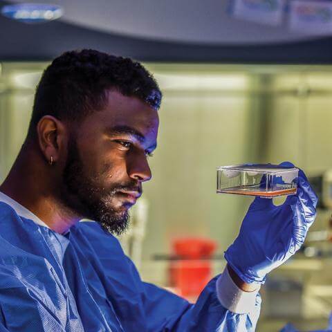 Howard student performing science experiment