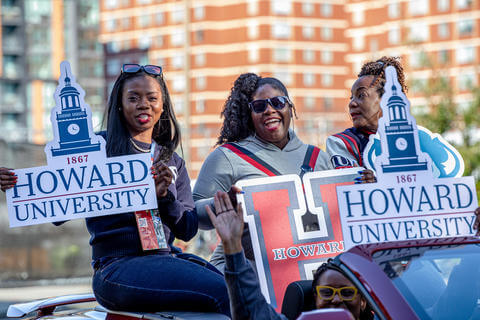 HUAA members smiling in Homecoming parade