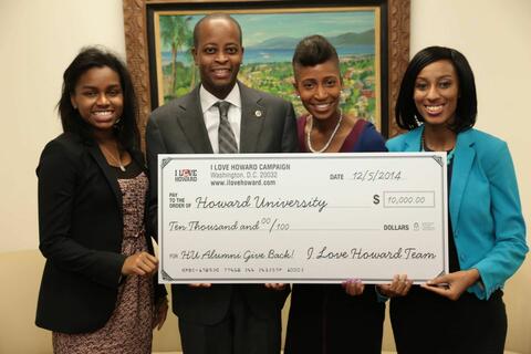 Michelle Janaye Nealy with others holding big check