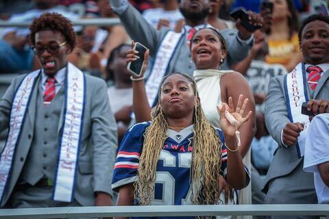 Bison fan and students dancing