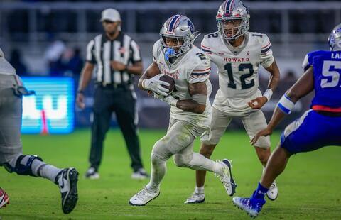 Bison player running with football