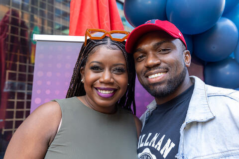 Two young Howard alumni smiling at camera