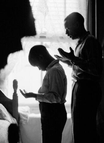 Gordon Parks photo of man and young boy with palms upward