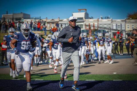 Bison football team running onto field