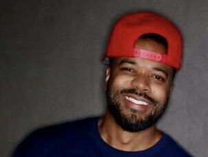 Bryndan Moore wearing a red backwards hat and a t-shirt